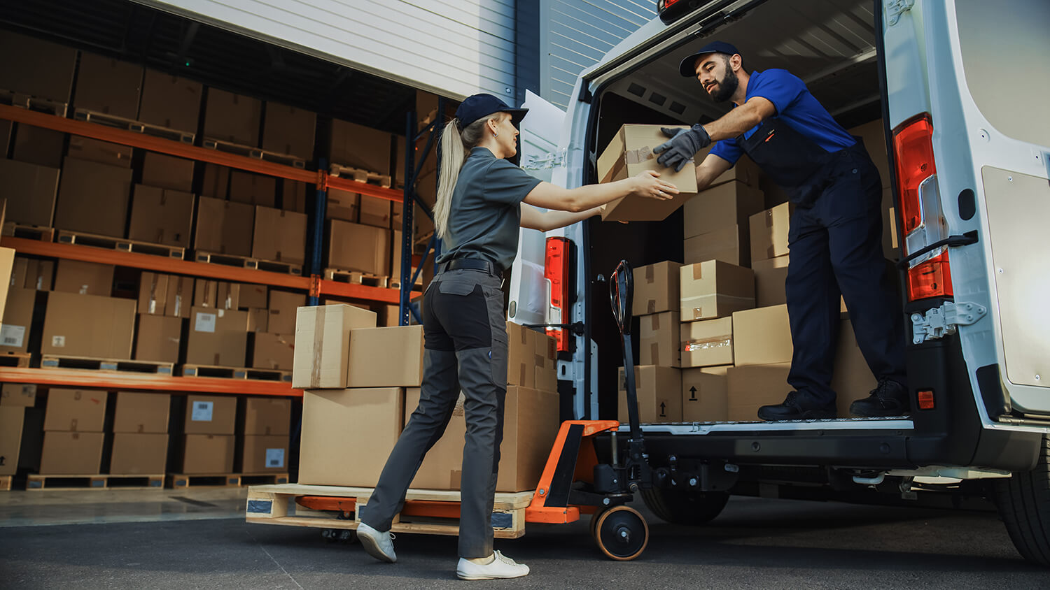 Workers loading boxes onto a shipping truck.