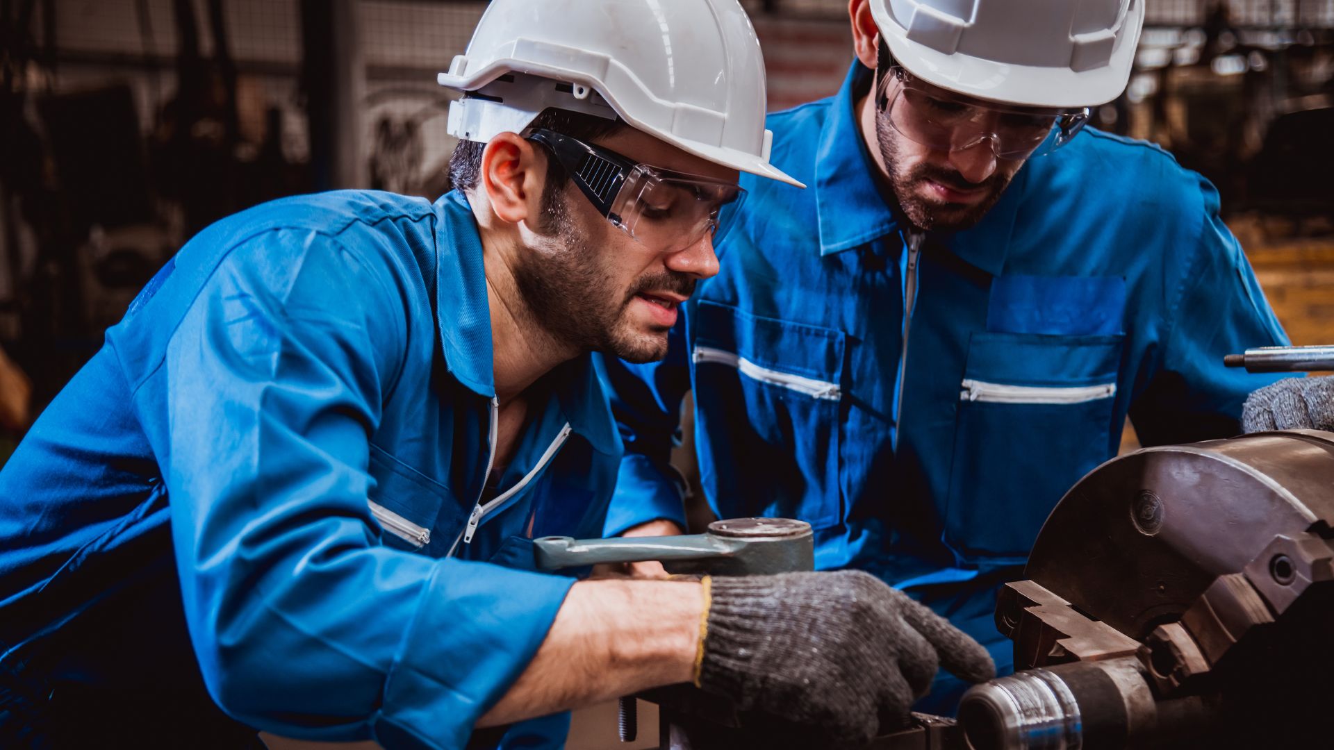 Worker operating equipment in an industrial facility